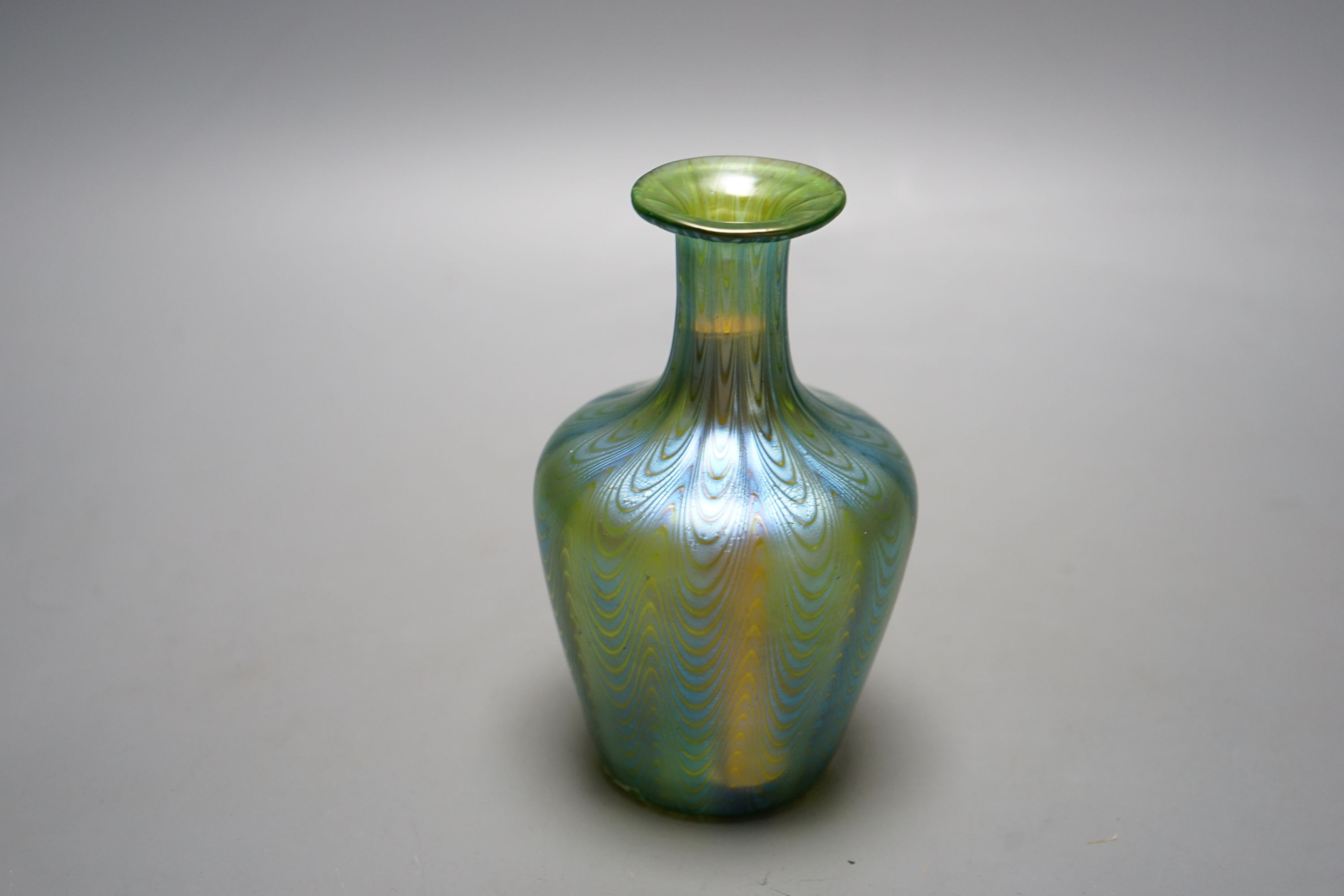 A Loetz style iridescent glass vase, flared narrow neck and bulbous body waved decoration, 14 cms high.